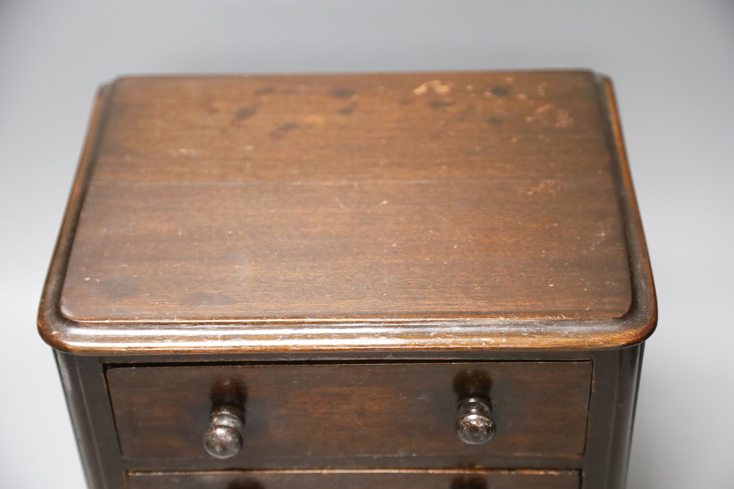 A Victorian miniature mahogany chest of 3 drawers 27cm